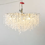 Lit against a plain grey backdrop, this Clérachic ceiling light in silver glows through its clear glass discs, hung from a test rig.