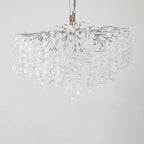 Unlit against a plain grey backdrop, this Clérachic ceiling light in silver hangs from a test rig, its clear glass discs still.