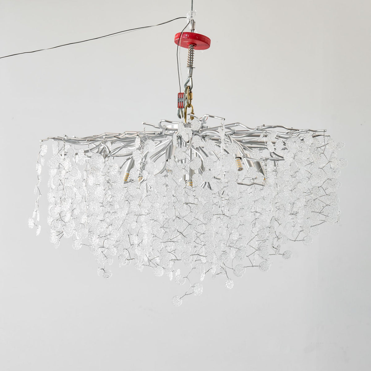 From a low angle, this unlit Clérachic ceiling light in silver shows its full spread of branches and clear glass discs.