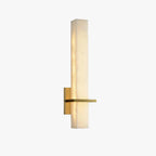 Studio shot of the alabaster wall light on white, lit, angled to show the brass arm and wall backplate