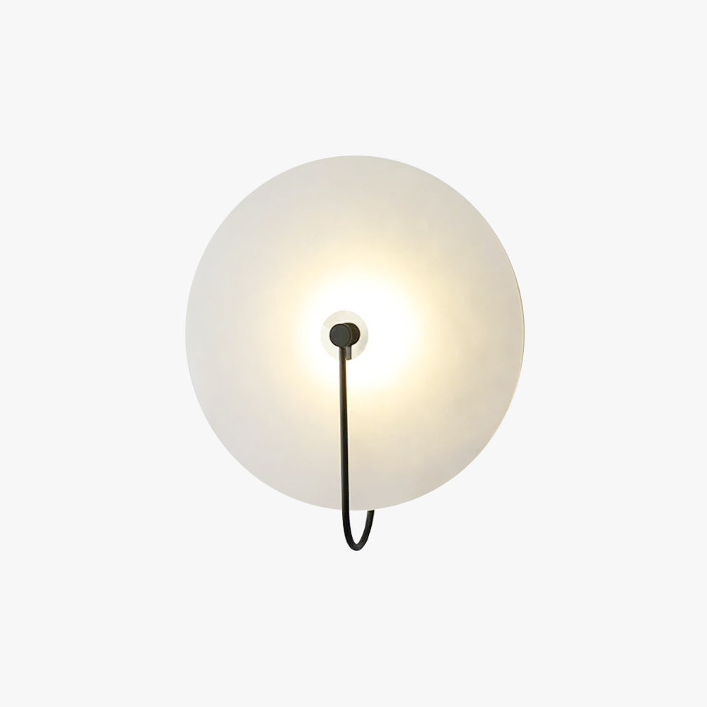 The Kristy wall lamp in black on a plain white background, showing the full round disc and slim hooked arm.