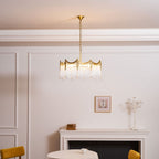 Copper-finish chandelier with clear glass shades over a dining room table