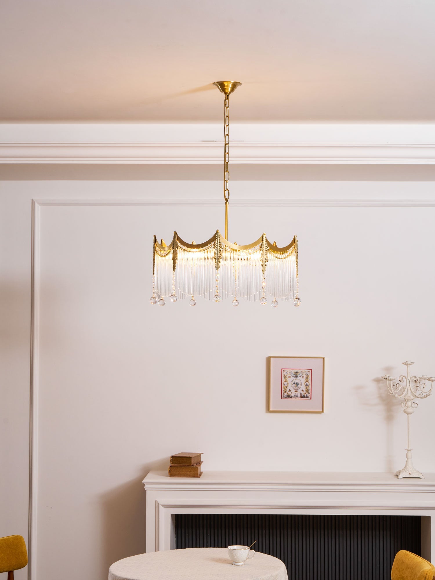 Copper-finish chandelier with clear glass shades lit in a warm room
