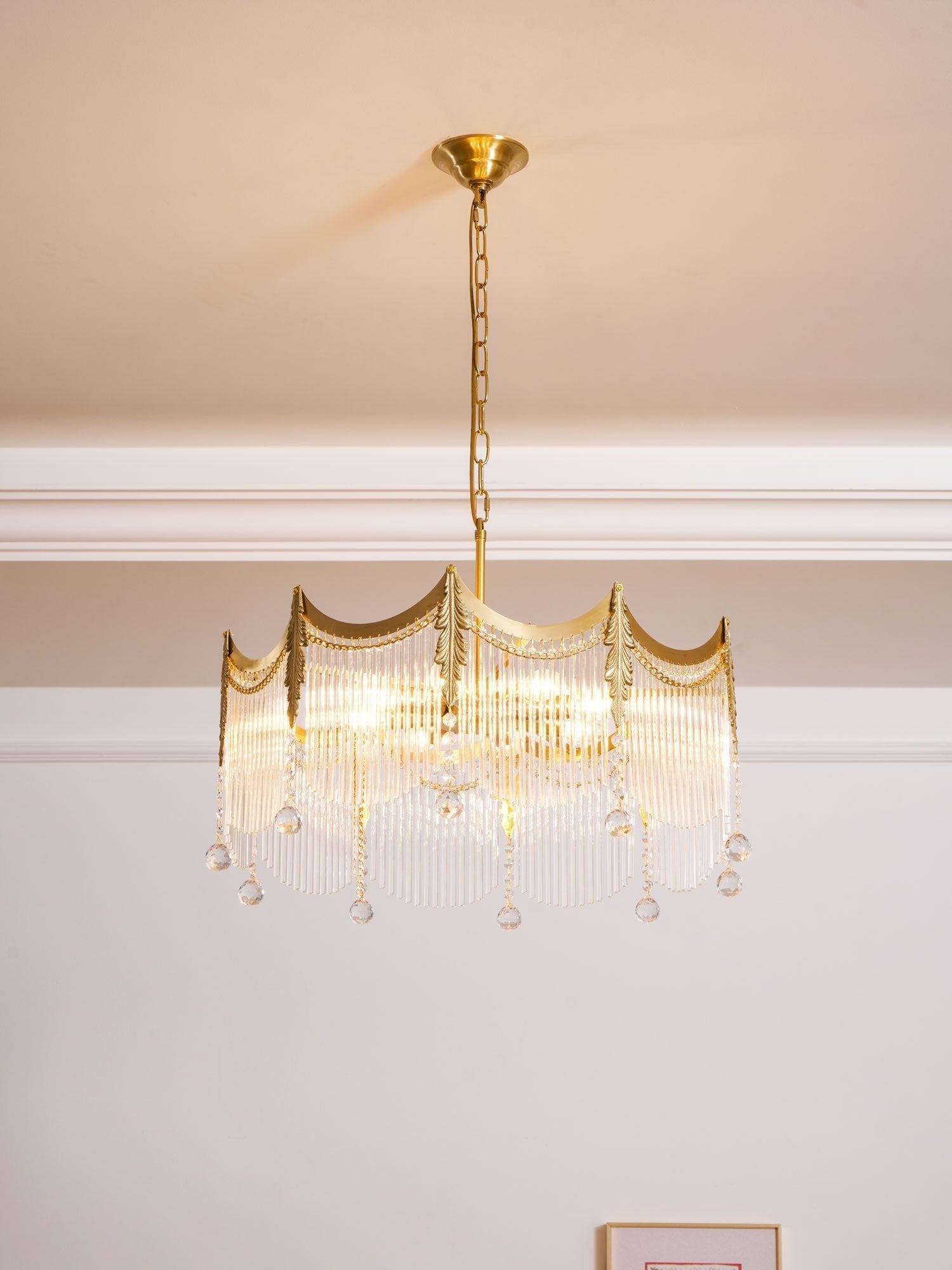 Side view of copper chandelier holding multiple clear glass shades