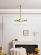 Multi-light copper chandelier with clear glass shades casting a warm glow