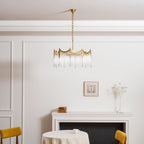 Copper-finish chandelier with clear glass shades suspended from a ceiling
