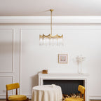 Copper chandelier with clear glass shades displayed in a styled room