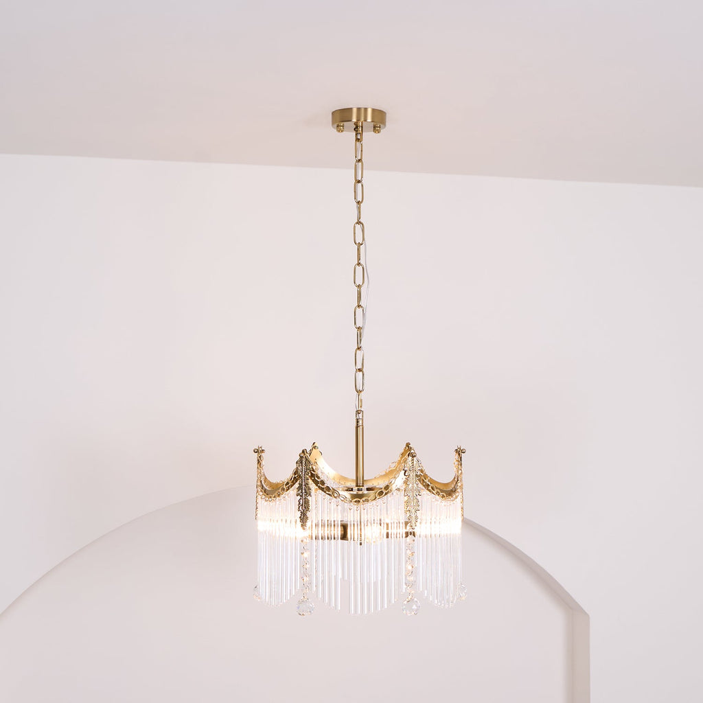 Copper-finish chandelier with clear glass shades suspended over a table