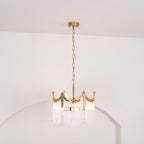 Copper-finish chandelier with clear glass shades suspended over a table