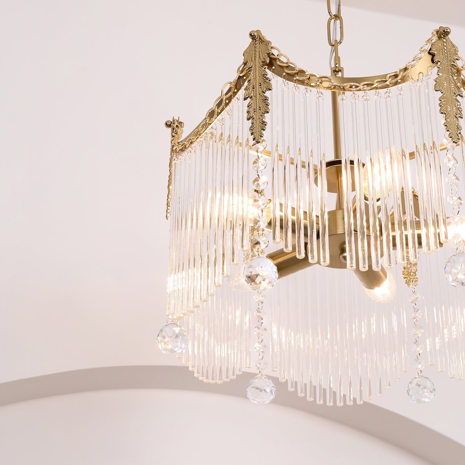 Copper chandelier with clear glass shades glowing in a cozy interior