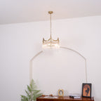 Copper-finish chandelier with clear glass shades shown in full detail