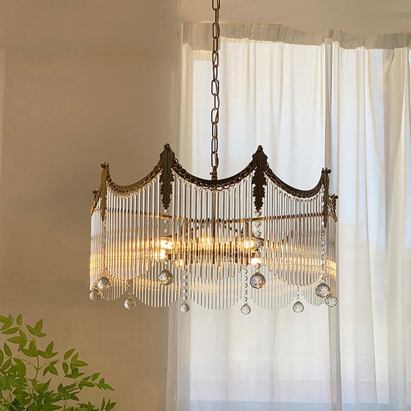 Detail of copper chandelier arms holding clear glass globe shades