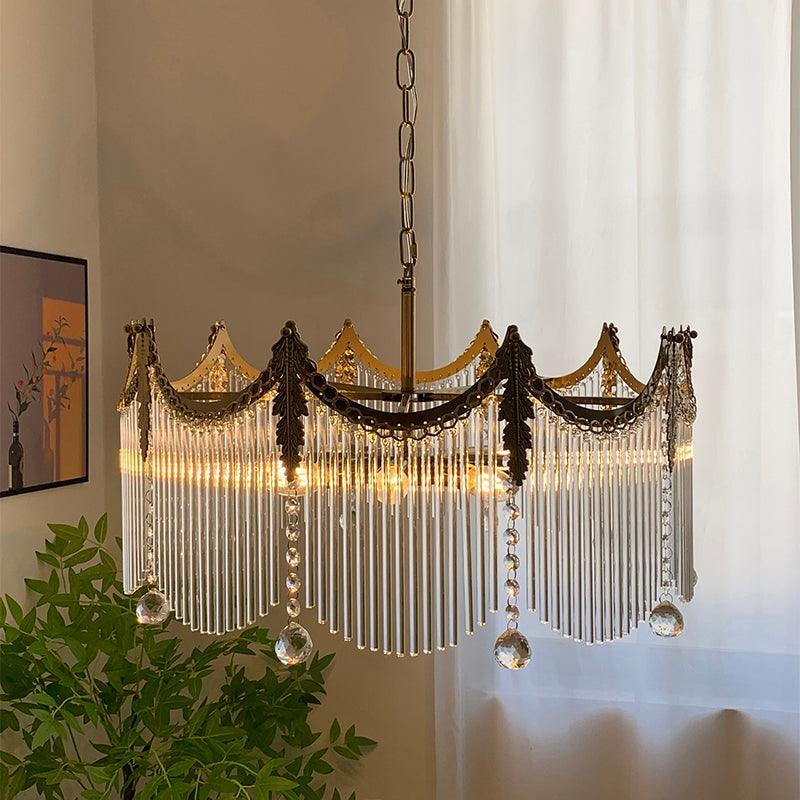 Copper-finish chandelier with clear glass shades illuminated in a living room