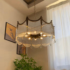 Copper chandelier with clear glass shades casting warm light overhead
