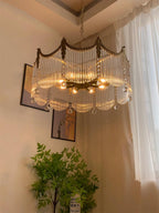 Close detail of copper finish and clear glass shade on the chandelier