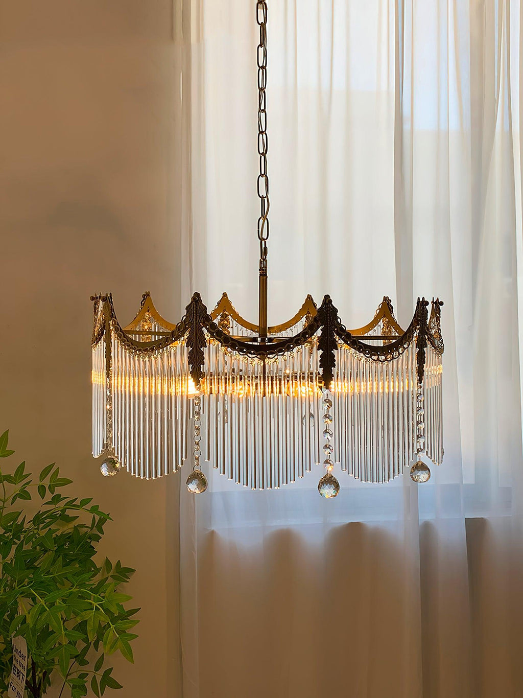 Copper chandelier with clear glass shades glowing against a dark wall