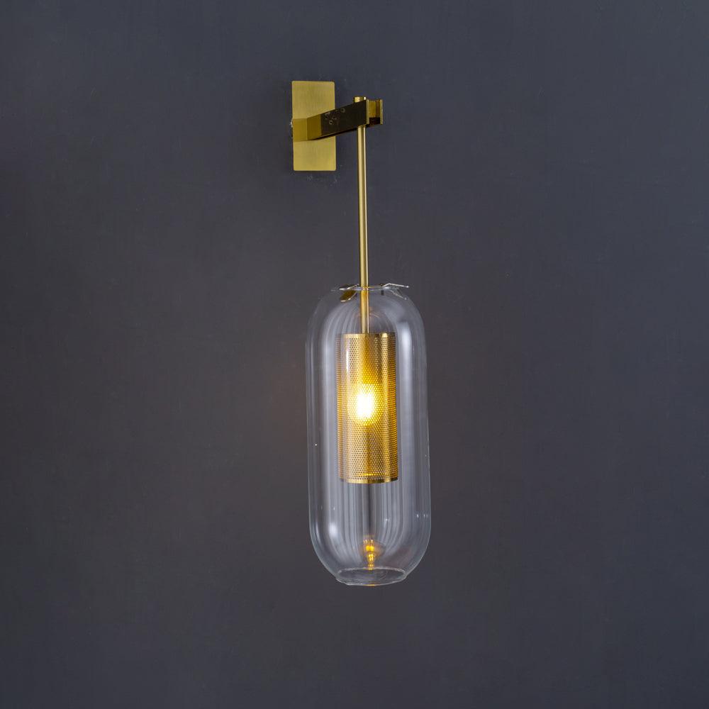 Brass wall lamp with glass shade displayed in a bright room
