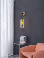 Brass glass wall lamp casting soft light in a refined room