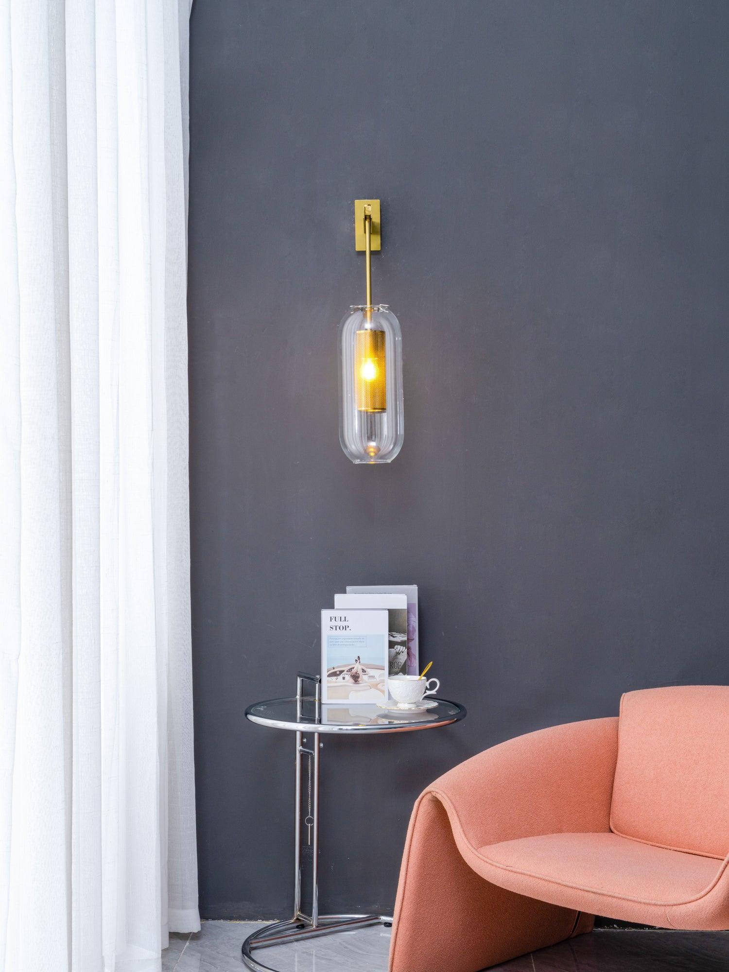 Wall lamp with metal arm and glass shade against a warm-toned wall