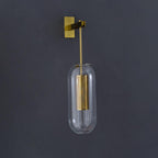 Wall lamp with metal arm and glass shade lighting a hallway