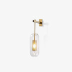 Glass wall lamp with metal arm shown in full against a wall