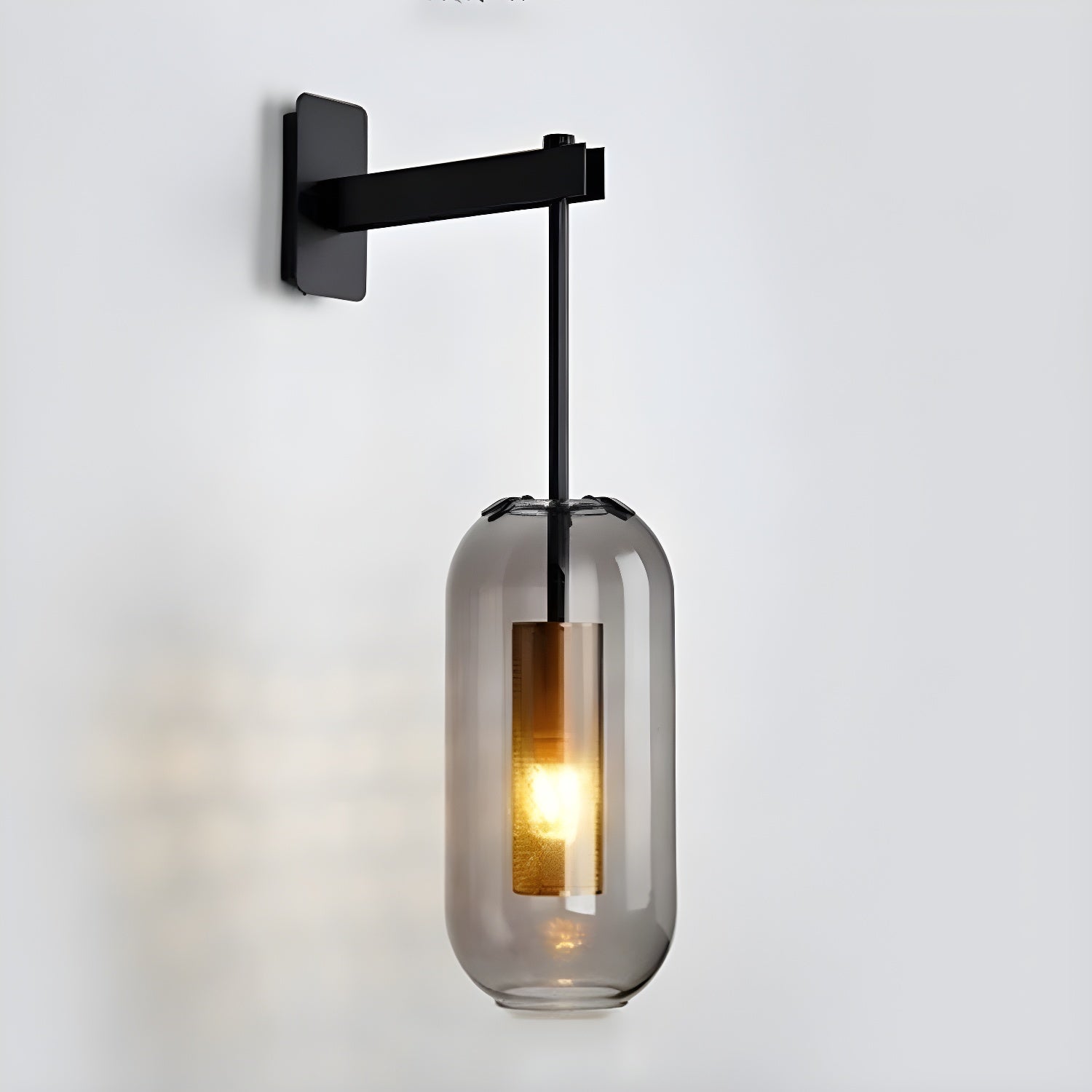 Wall lamp with glass shade detail highlighting its slim metal arm