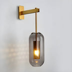 Glass wall lamp with copper finish illuminated in a styled room