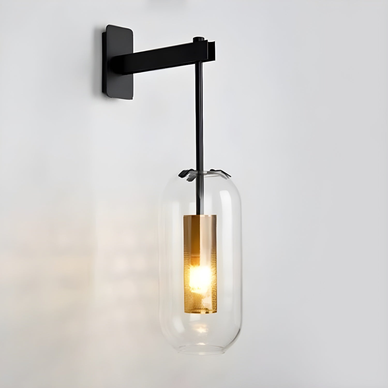 Wall lamp with slim metal arm and glass shade glowing warmly indoors