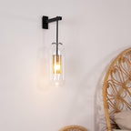 Glass wall lamp casting warm light in a quiet interior corner