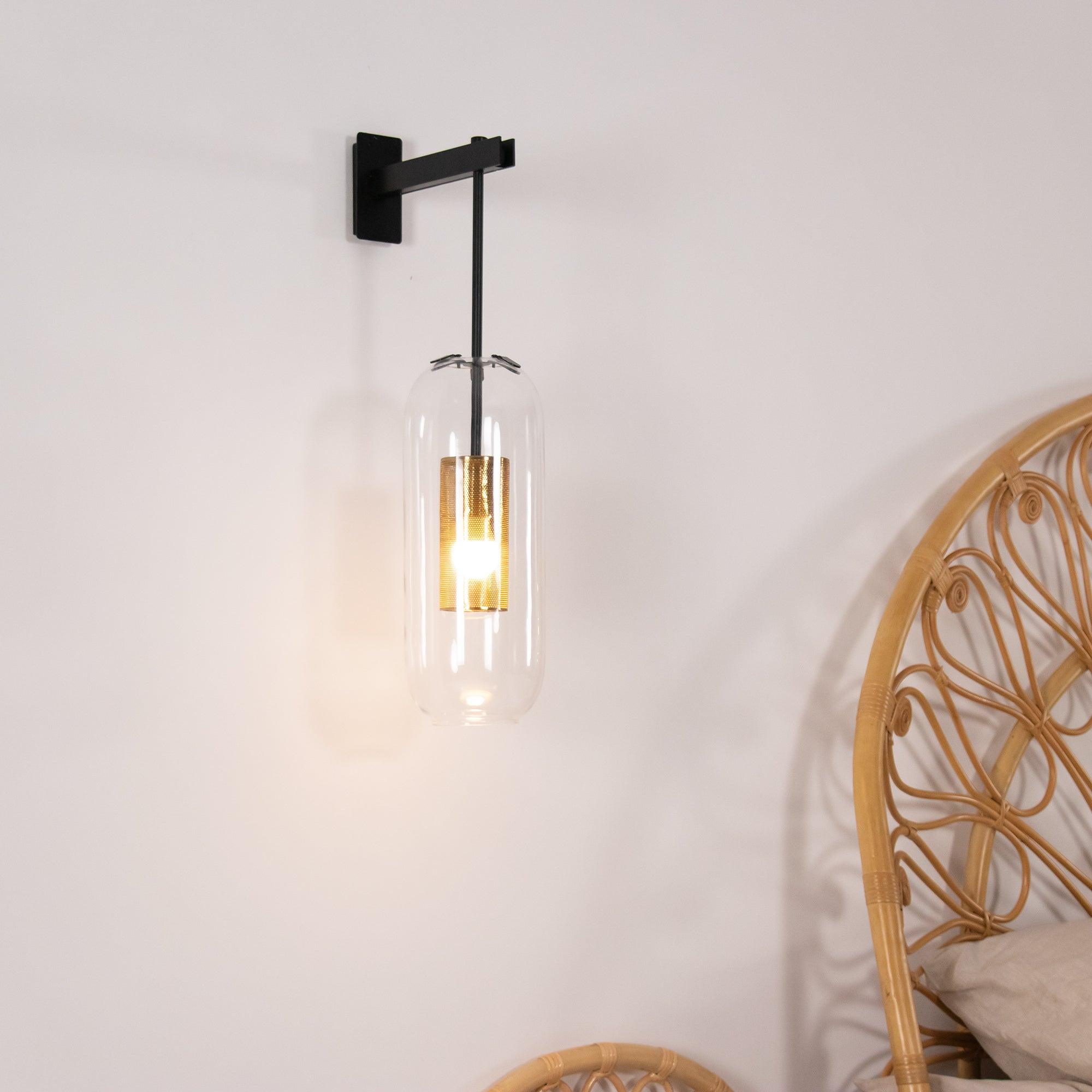 Glass wall lamp casting warm light in a quiet interior corner