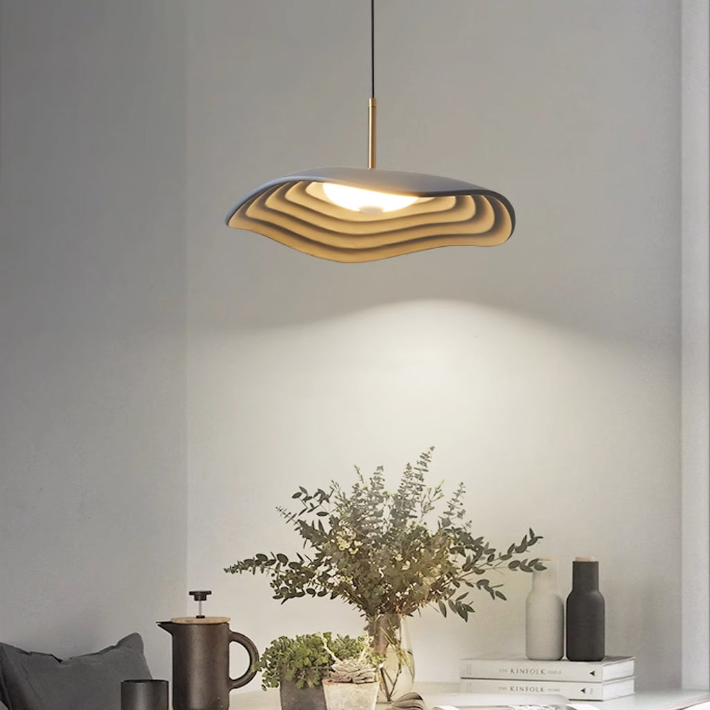 Pendant light with clean disc shade in a styled interior