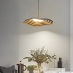 Pendant light with clean disc shade in a styled interior