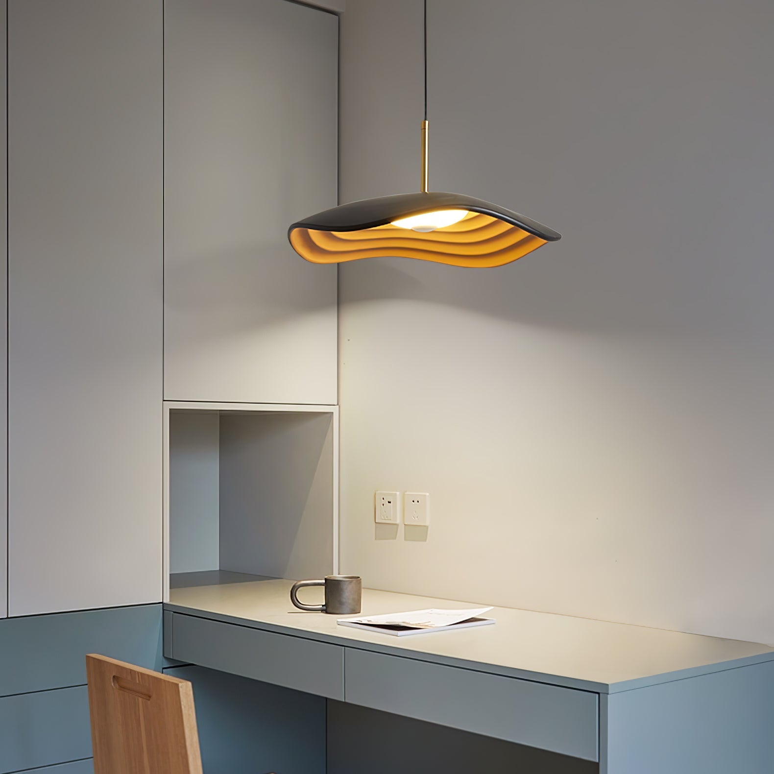White disc pendant light shown in a bright open space