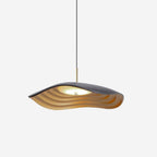 Pendant light with clean disc form glowing over a kitchen island