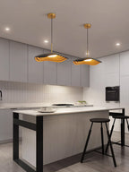 Pendant light glowing over a dining area with warm light
