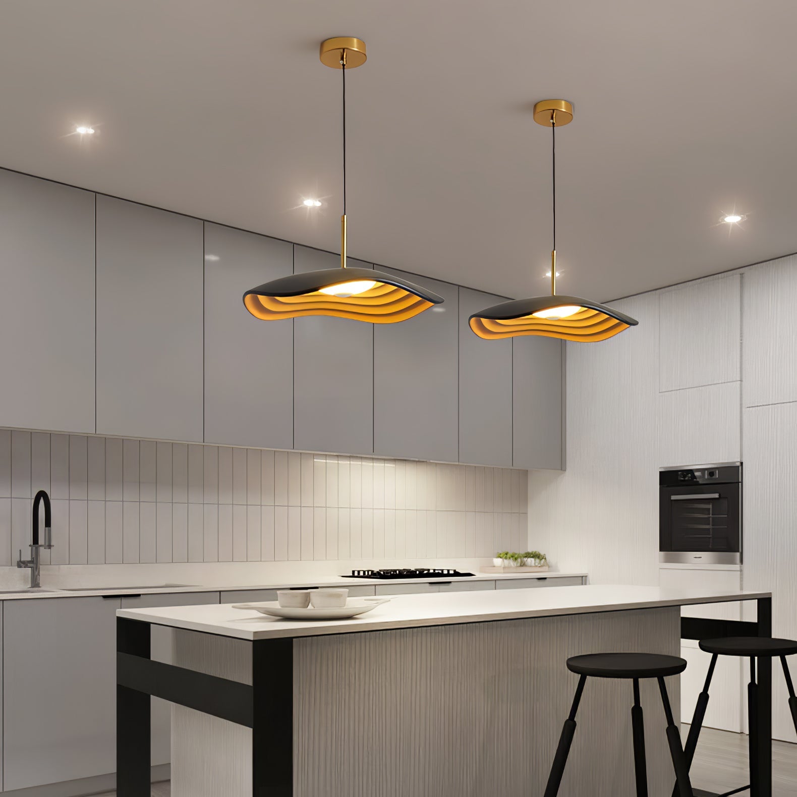Pendant light suspended above a kitchen island casting warm glow