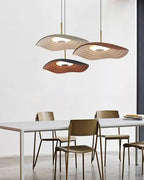 Black disc pendant light suspended in a minimal interior