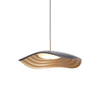 Pendant light glowing warmly above a styled dining setting
