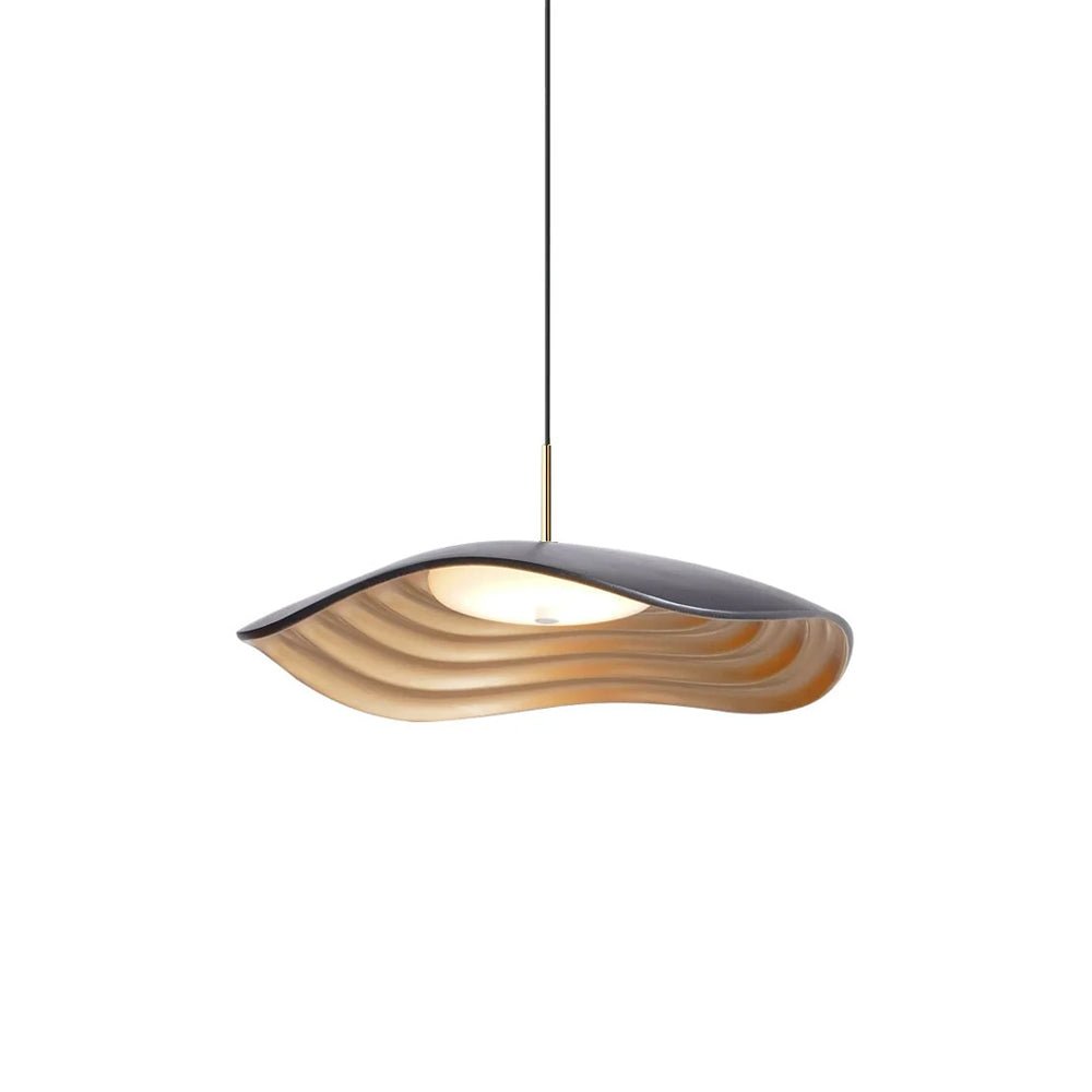 Disc-shaped pendant light glowing warmly above a kitchen counter