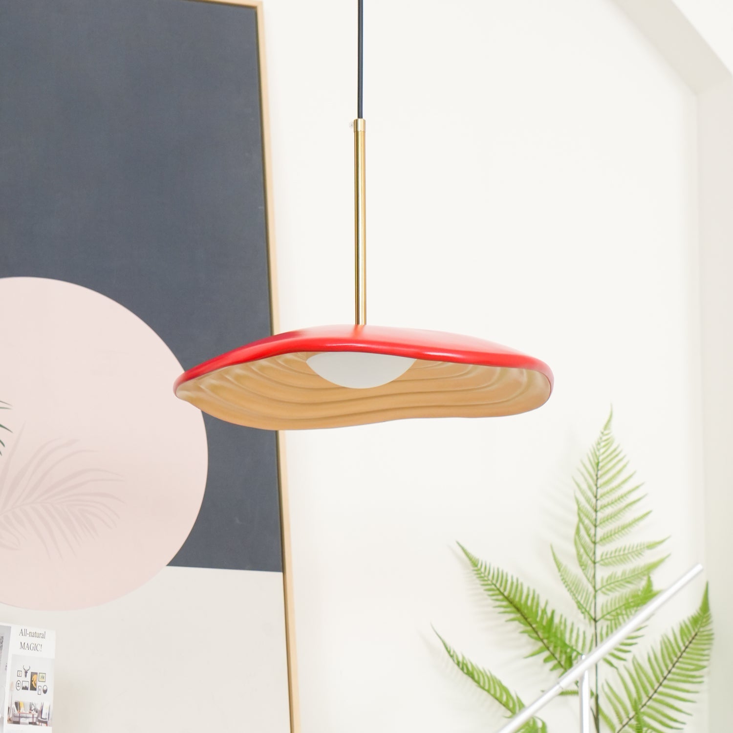 Disc pendant light suspended above a modern dining table