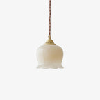 Petal pendant light with brass finish shown against a plain backdrop