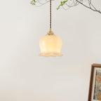 Flower pendant light in brass and white shown from the side
