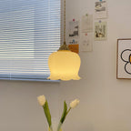 Brass pendant light with sculpted petal shade in an interior nook