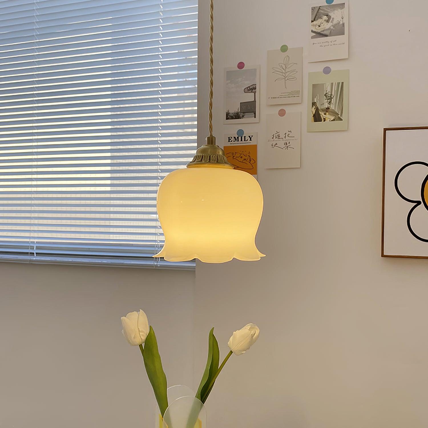 Brass pendant light with sculpted petal shade in an interior nook