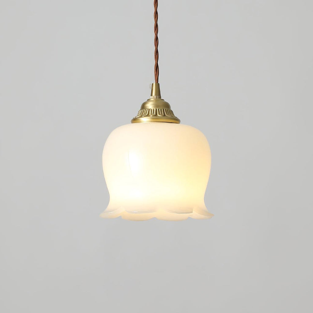 Petal-shaped pendant light in brass and white suspended from a cord