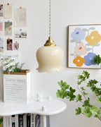 Brass flower pendant light casting soft light in a quiet room