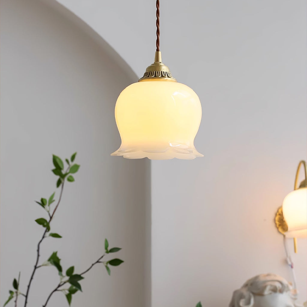 Flower-shaped brass pendant light casting a warm glow