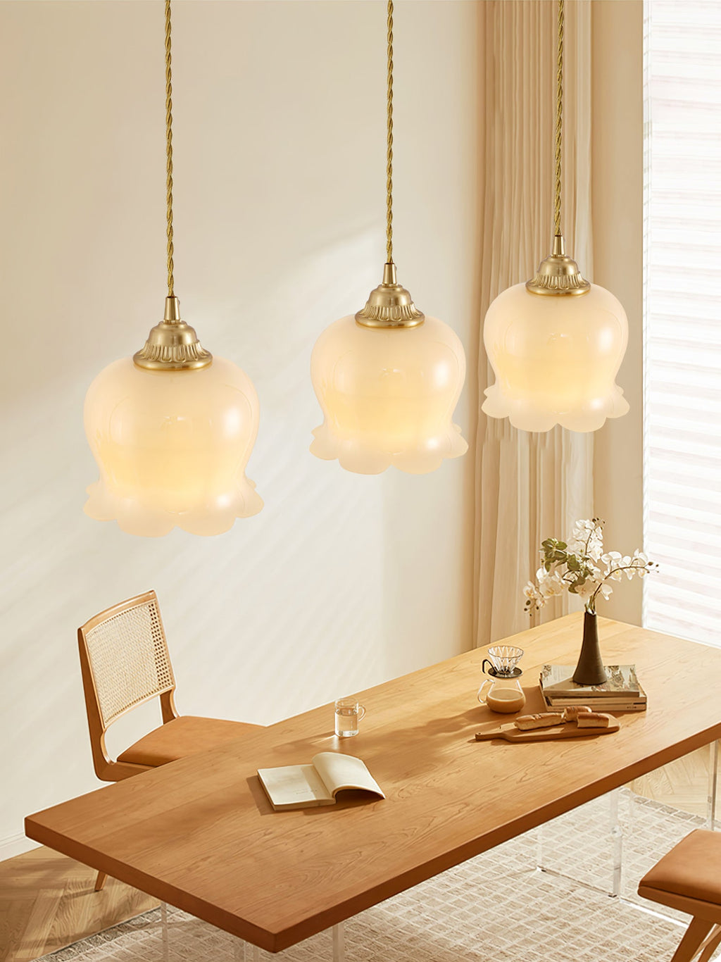 Brass pendant light with beige petal shade in a cozy corner
