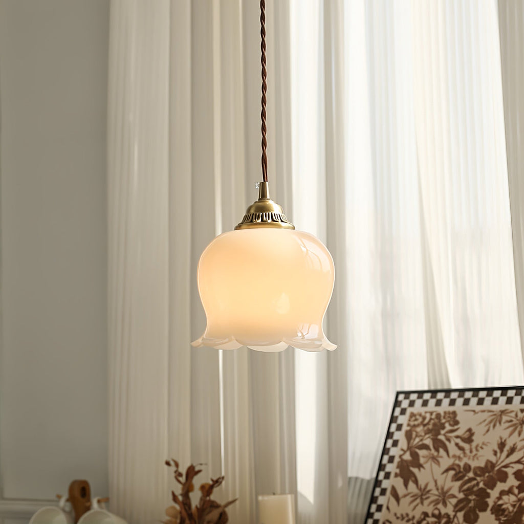 Brass petal pendant light shown hanging in a styled nook