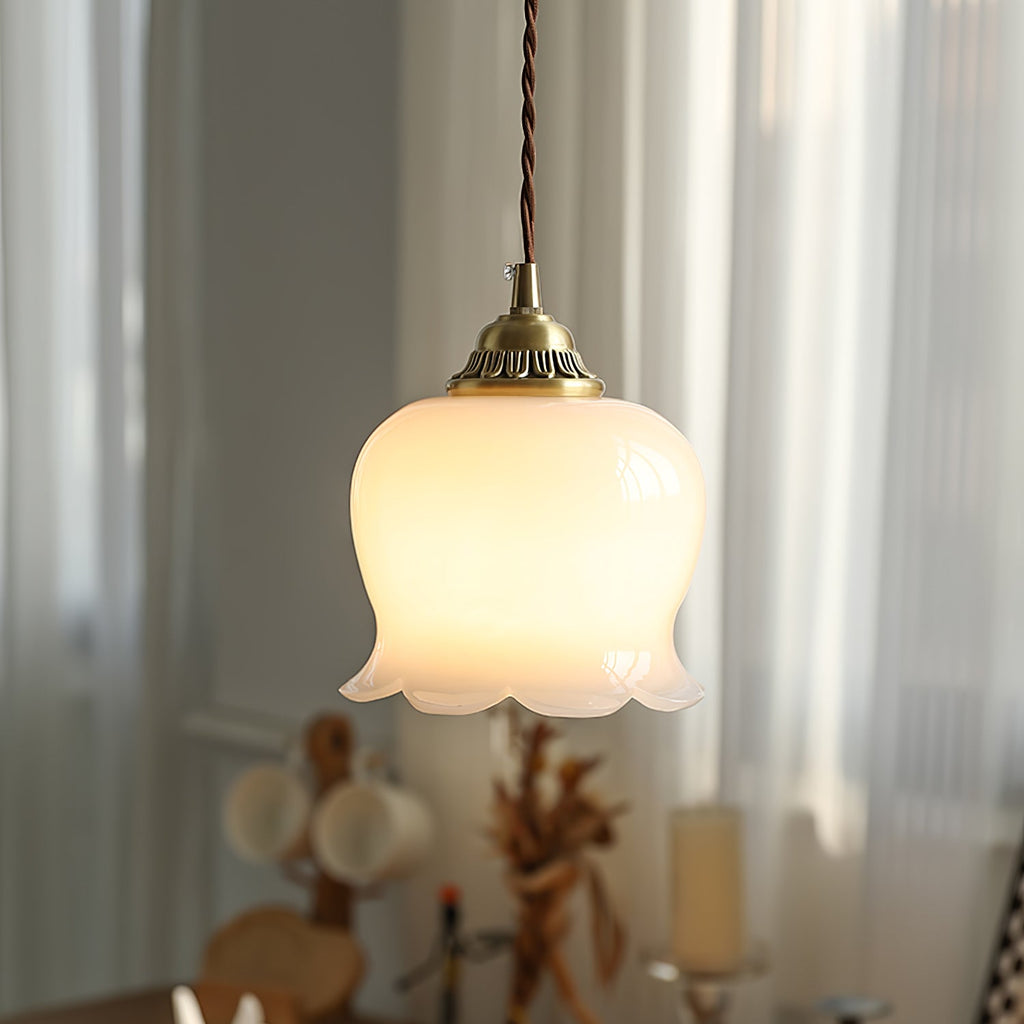 Petal pendant light with brass finish suspended in an interior